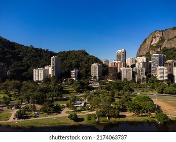 Aerial View Of Rodrigo De Freitas Lagoon, South Zone Of Rio De Janeiro, Brazil. In The Background, The Beaches Of Ipanema And Leblon. Sunny Day. Cars Traveling On Avenida Epitácio Pessoa. Drone Photo.