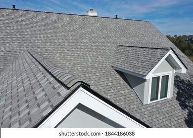 Aerial view of roof work done on a home. - Shutterstock ID 1844186038