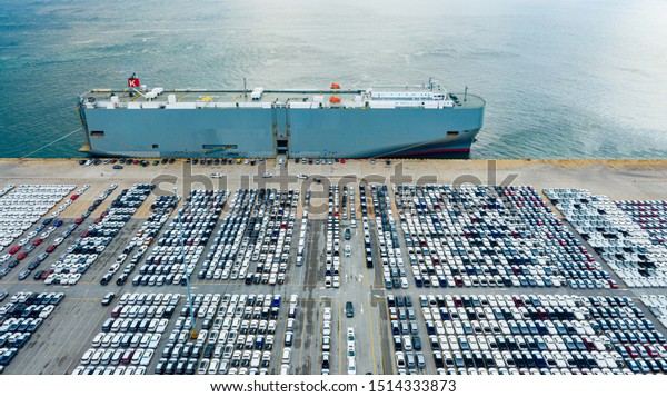Aerial view\
ro-ro ship, Cargo ship transportation of business logistic sea\
freight, New Cars produced by year up in the port for Cargo ship\
and Cargo import-export around in the\
world