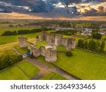 Aerial view of Roscommon castle  in Ireland, Anglo Norman stronghold with quadrangular shape with large round towers on the corners with dramatic colorful sunset sky