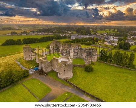 Aerial view of Roscommon castle  in Ireland, Anglo Norman stronghold with quadrangular shape with large round towers on the corners with dramatic colorful sunset sky