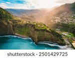 Aerial view of rough ocean with  huge cliff and waves, volcanic beach in Guindaste viewpoint in faial, Madeira, Portugal