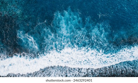 Aerial view of rough ocean with waves, volcanic beach in Ponta do Sol, Madeira, Portugal