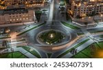 Aerial view of a roundabout circle road in Dubai downtown from above night timelapse. Traffic on the street. Dubai, United Arab Emirates.