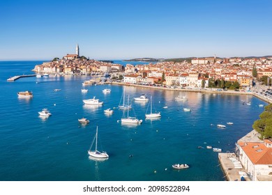 an aerial view of Rovinj, port with boats and ships, in background church of St. Euphemia, Istria, Croatia