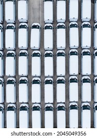 An Aerial View Of Rows Of New White Vans Fresh Of The Production Line In A Car Manufacturer's Factory