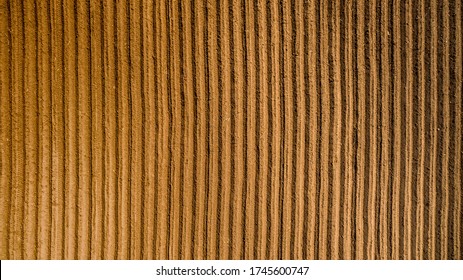 Aerial View ; Rows Of Soil Before Planting. Furrows Row Pattern In A Plowed Field Prepared For Planting Crops In Spring. Aerial View Of Land Prepared For Planting And Cultivating The Crop.