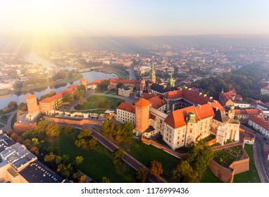 Aerial view Royal Wawel Castle and Gothic Cathedral in Cracow, Poland, with Renaissance Sigismund Chapel with golden dome, fortified walls, yard, park and tourists.