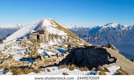 Aerial view of Ruderi Alpe di Tremezzo, abandoned rural buildings in Italian Alps. Drone view of Como and Lecco mountain in Brianza, north Italy. Abandoned rural mountain house of the world war.