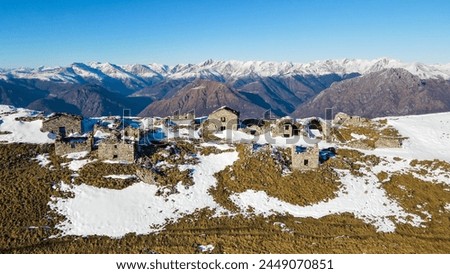Aerial view of Ruderi Alpe di Tremezzo, abandoned rural buildings in Italian Alps. Drone view of Como and Lecco mountain in Brianza, north Italy. Abandoned rural mountain house of the world war.