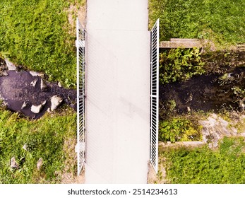 Aerial view of running path, jogging trail with bridge in the middle of park. Running training, no people. - Powered by Shutterstock