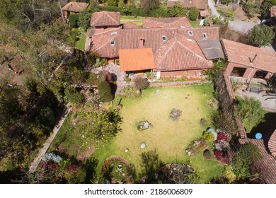 Aerial view of a rural house in the countryside of Cusco Peru. House in Yucay town with roof tiles.