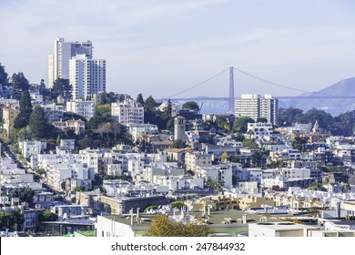 Aerial view of Russian Hill, North Beach, and Little Italy area of San Francisco. Golden Gate Bridge in the background.
