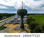 An aerial view of a rusting old water tower on a cloudy day in Smyrna, Delaware