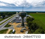 An aerial view of a rusting old water tower on a cloudy day in Smyrna, Delaware