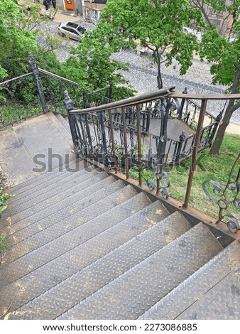 aerial view of rusty stairs, rusty metal stairs going down, rusty iron steps and handrails. Example of steampunk retro style interior part with copyspace. Industrial textured rusted stairs