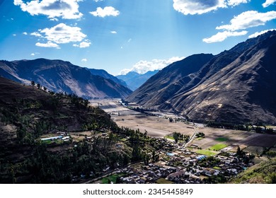 Aerial view Sacred Valley: Andes Mountains: Captures Meandering river, and villages in Andes. Majestic peaks frame harmonious nature-human coexistence in vibrant landscape. - Powered by Shutterstock