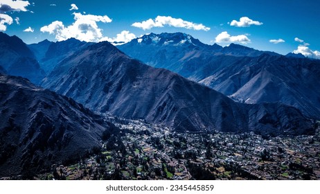 Aerial view Sacred Valley: Andes Mountains: Captures Meandering river, and villages in Andes. Majestic peaks frame harmonious nature-human coexistence in vibrant landscape. - Powered by Shutterstock