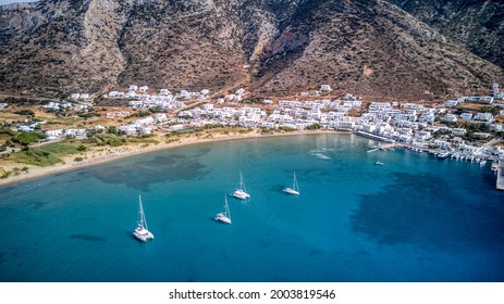 Aerial view of sailboats anchored in the turquoise Kamares bay on Sifnos island, Greece - Shutterstock ID 2003819546