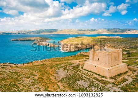Aerial view of Saint Mary's Tower on Comino island. Drone landscape. Cloudy blue sky. Europe. Malta country