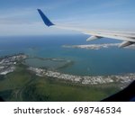 Aerial view of San Juan and other districts in Puerto Rico heading to the International Airport, seen from an airplane window.