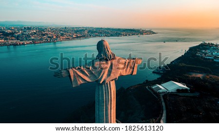 Aerial view of Sanctuary of Christ the King, Santuario de Cristo Rei and Lisbon city, Portugal. Drone photo at sunrise. Catholic monument