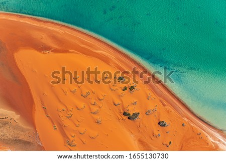 An aerial view of sand dunes and the beach in the Shark Bay region of Western Australia. Image captured shooting out of a Cessna with the door off.