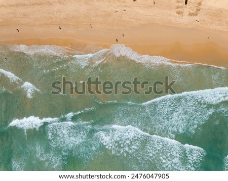 Similar – Luftaufnahme von fliegenden Drohnen von Menschen, die sich am Algarve Beach in Portugal entspannen.