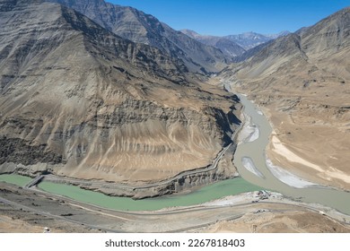 Aerial view of Sangam – the confluence of the Indus river (green colour) and the Zanskar river (blue or brown colour depending on the season) in Ladakh, India.	 - Powered by Shutterstock