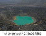 Aerial view of Santa Ana volcano crater with bright turquoise steaming lake water.