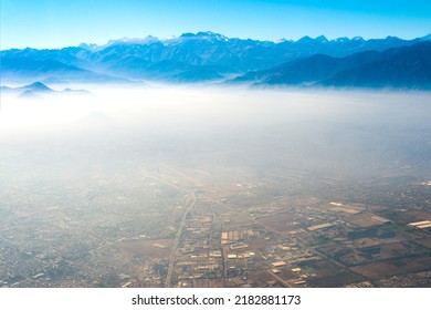 Aerial view of Santiago de Chile under a layer of smog with the Andes mountain range in the back - Shutterstock ID 2182881173