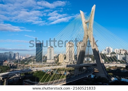 Aerial view of Sao Paulo city skyline, marginal Pinheiros avenue, modern Cable stayed bridge, Pinheiros River and corporate buildings in sunny summer day. Brazil, South America.