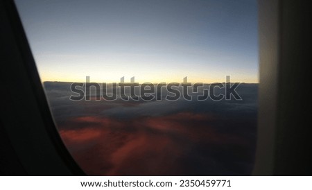 Aerial view scene of a sunset hiding under white fluffy clouds