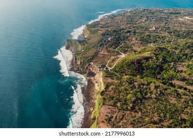 Aerial view of scenic coastline with cliffs and ocean with waves in Uluwatu, Bali island