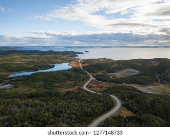 Aerial View Of A Scenic Road On A Rocky Atlantic Ocean Coast During A Cloudy Sunset. Taken In Twillingate, Newfoundland, Canada.