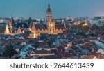 Aerial view of Schaerbeek Town Hall day to night transition timelapse in Brussels, Belgium. Neo-Renaissance architecture surrounded by illuminated red-roofed houses. Cityscape and historical charm