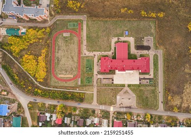 Aerial View Of A School Or College Campus With Stadium At Village Or Town