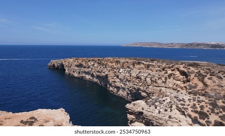 Aerial view of the sea caves of Cominotto uninhabited island near Comino, Maltese islands. Seagull flying in the frame. High quality photo - Powered by Shutterstock