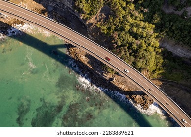 Aerial view of Sea cliff bridge at the edge of steep sandstone cliff on the Grand Pacific drive along pacific coast of Australia, NSW. - Powered by Shutterstock