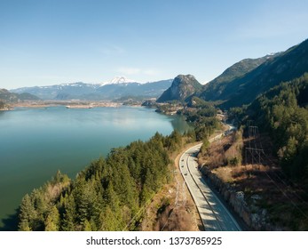 Aerial view of Sea to Sky Highway with Chief Mountain in the background during a sunny day. Taken near Squamish, North of Vancouver, British Columbia, Canada.