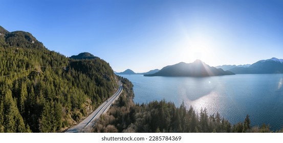 Aerial View of Sea to Sky Highway in Howe Sound. Sunset Sky. Between Squamish and Vancouver, BC, Canada. Panorama Background
