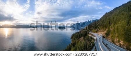 Aerial View of Sea to Sky Highway in Howe Sound. Sunset Sky. Between Squamish and Vancouver, BC, Canada. Panorama Background Stockfoto © 