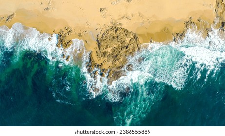 Aerial view of sea waves and fantastic Rocky coast. Aerial view Top down seashore. Waves crashing on rock cliff. Aerial drone top view of ocean's beautiful waves crashing on the rocky island coast.  - Powered by Shutterstock