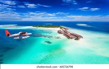 Aerial view of a seaplane approaching island in the Maldives