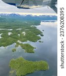 Aerial view from seaplane of Lake Iliamna with islands, Aleutian mountain range and reflection. Near Pedro Bay, Alaska. View from seaplane. 