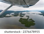 Aerial view from seaplane of Lake Iliamna with islands, Aleutian mountain range and reflection. Near Pedro Bay, Alaska. Aerial view from seaplane. 