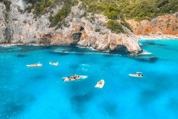 Aerial View Of Seascape With Boats On Blue Sea In The Morning At Dawn In Summer. Motorboats  With People On Sea Bay With Rocks In Clear Blue Water. Top View From Drone. Travel Holiday Background