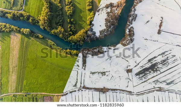 Aerial view of\
season change with river\
bend.