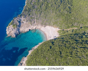 Aerial view of secluded beach cove with turquoise water and lush greenery. - Powered by Shutterstock