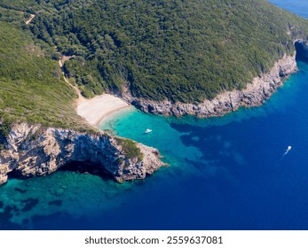 Aerial view of secluded beach cove with turquoise water and boats. - Powered by Shutterstock